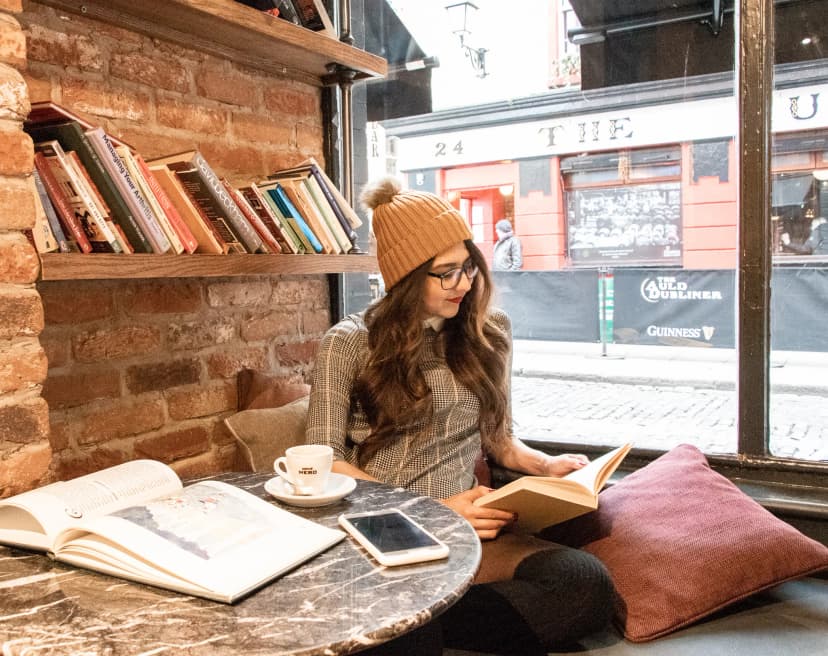a young woman reading in a cafe